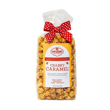 Load image into Gallery viewer, Popsations Crabby Caramel popcorn with a red polka dot bow
